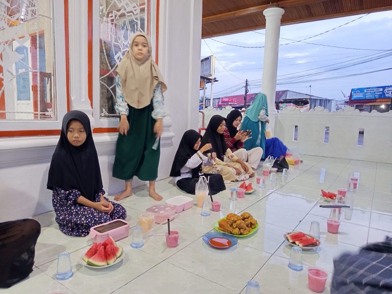 Puluhan anak Pesantren Ramadan di surau tersebut turun ke jalan membagikan ratusan takjil dan ayam goreng kepada pengguna jalan di ruas Tabing–Lubuk Minturun, Minggu (16/3/2026).