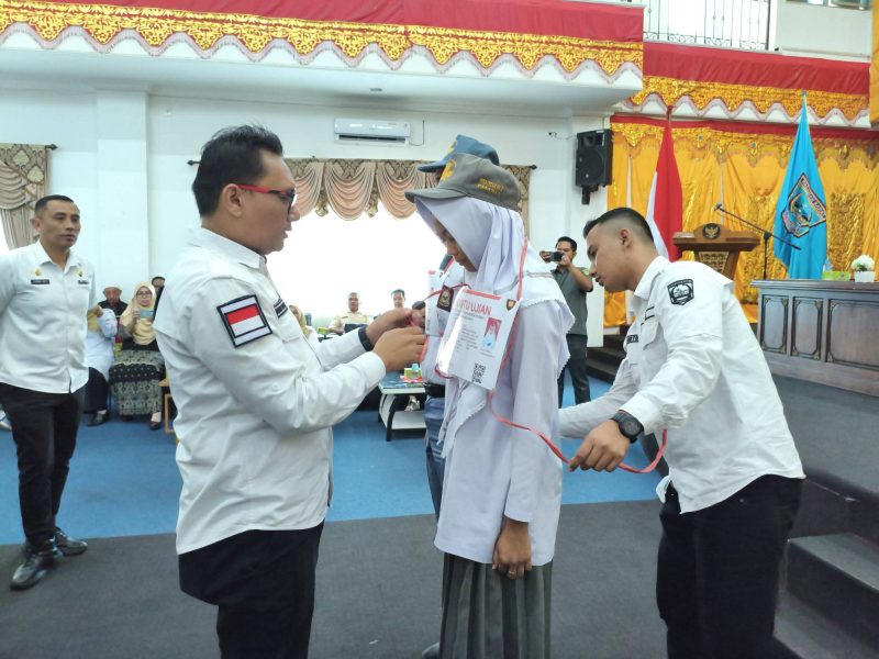 Sekda Pasaman Barat Doddy San Ismail memasang tanda peserta bakalan calon Paskibraka tingkat Kabupaten tahun 2026.